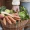 Mid section of a man holding basket full of vegetables