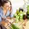 Young and happy woman eating healthy salad sitting